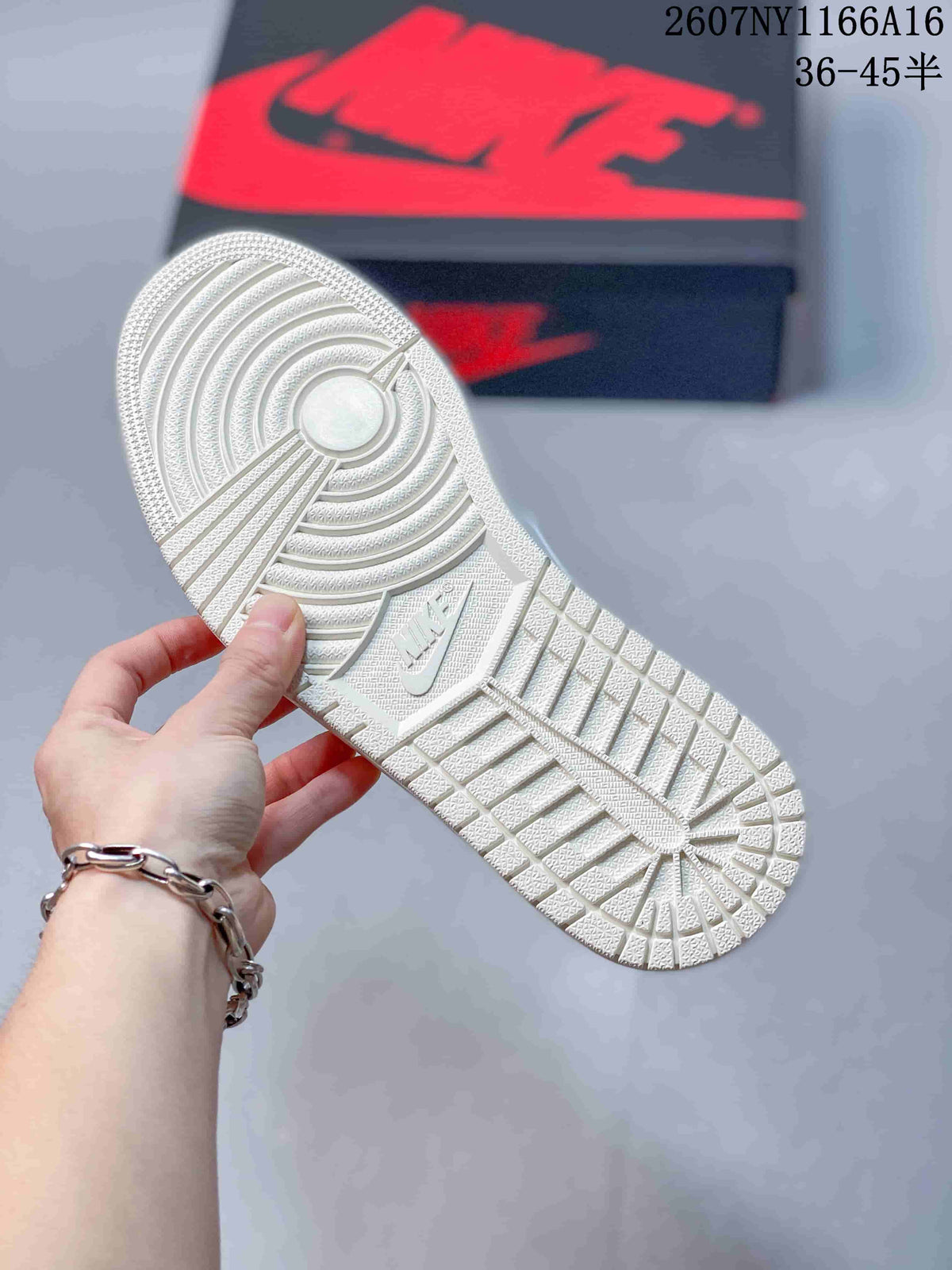 White sneaker outsole viewed from below, showing circular and geometric tread sections with a central swoosh detail; black-and-red shoebox in the background.