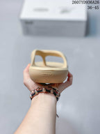Rear view of the beige sandal showing the raised heel area and open toe-post strap design.