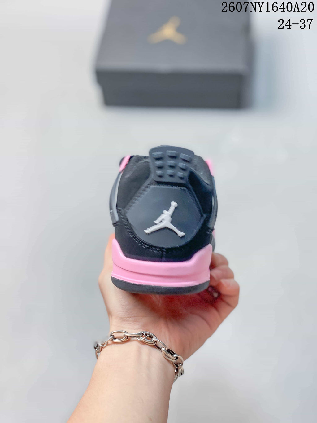 Rear view showing the padded black heel and pink heel accent.