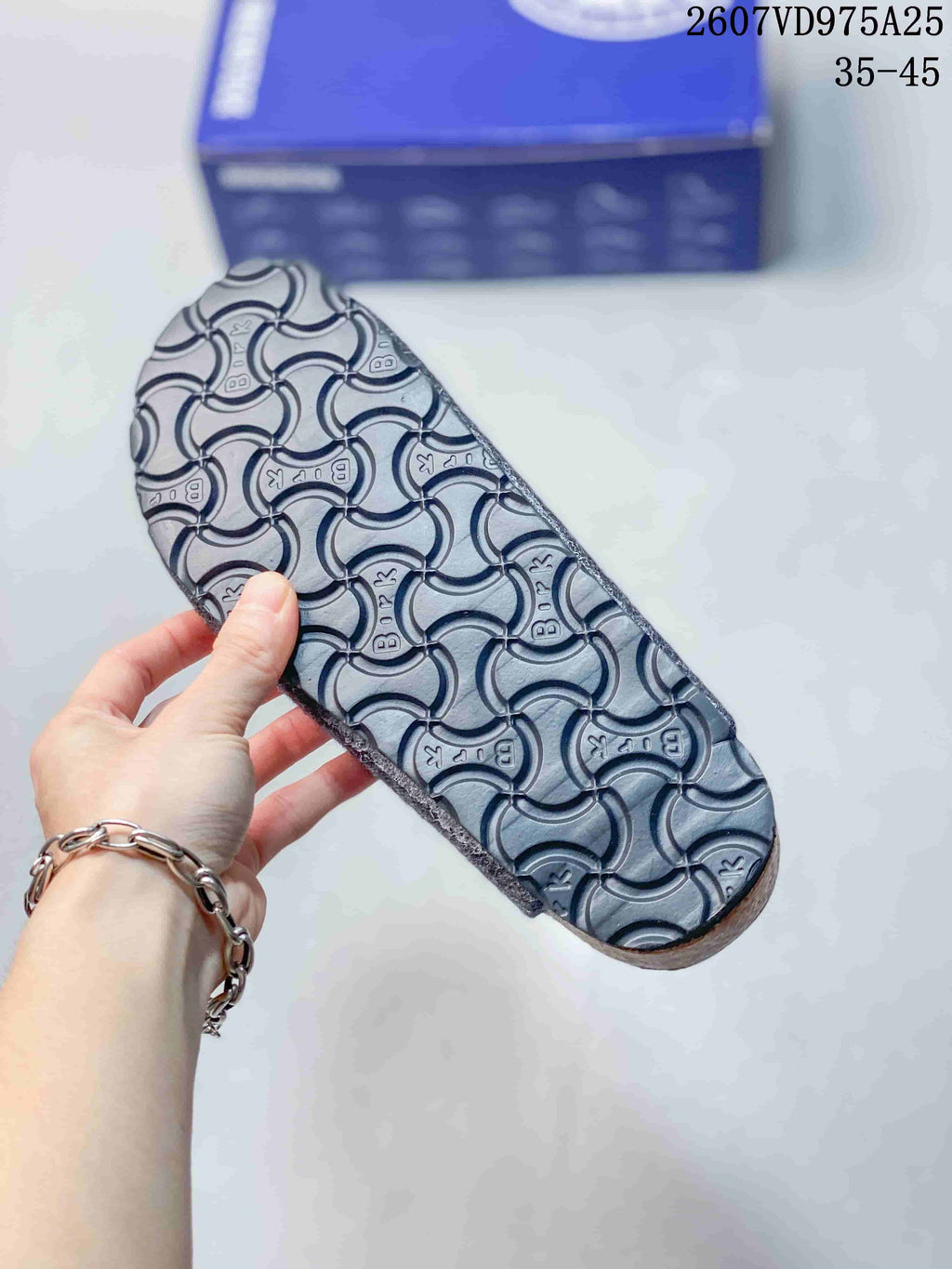 Close view of the clog outsole showing a repeating textured pattern.
