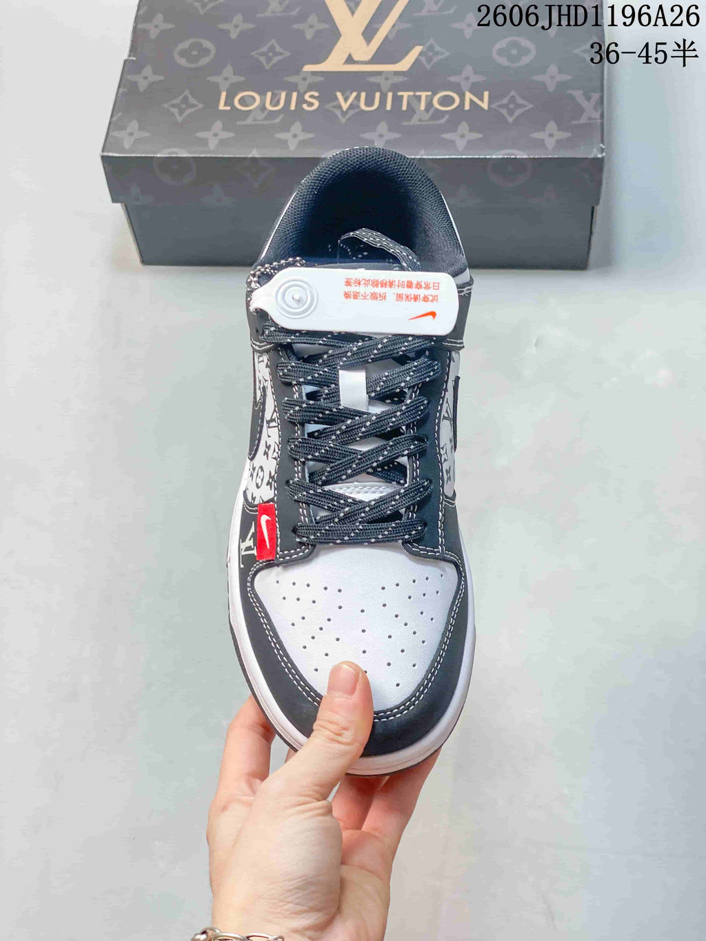 Front view of a sneaker with dotted laces and perforated toe panel