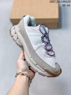 Angled side view of the sneaker showing the layered upper, padded collar, sculpted midsole and tan outsole accents.