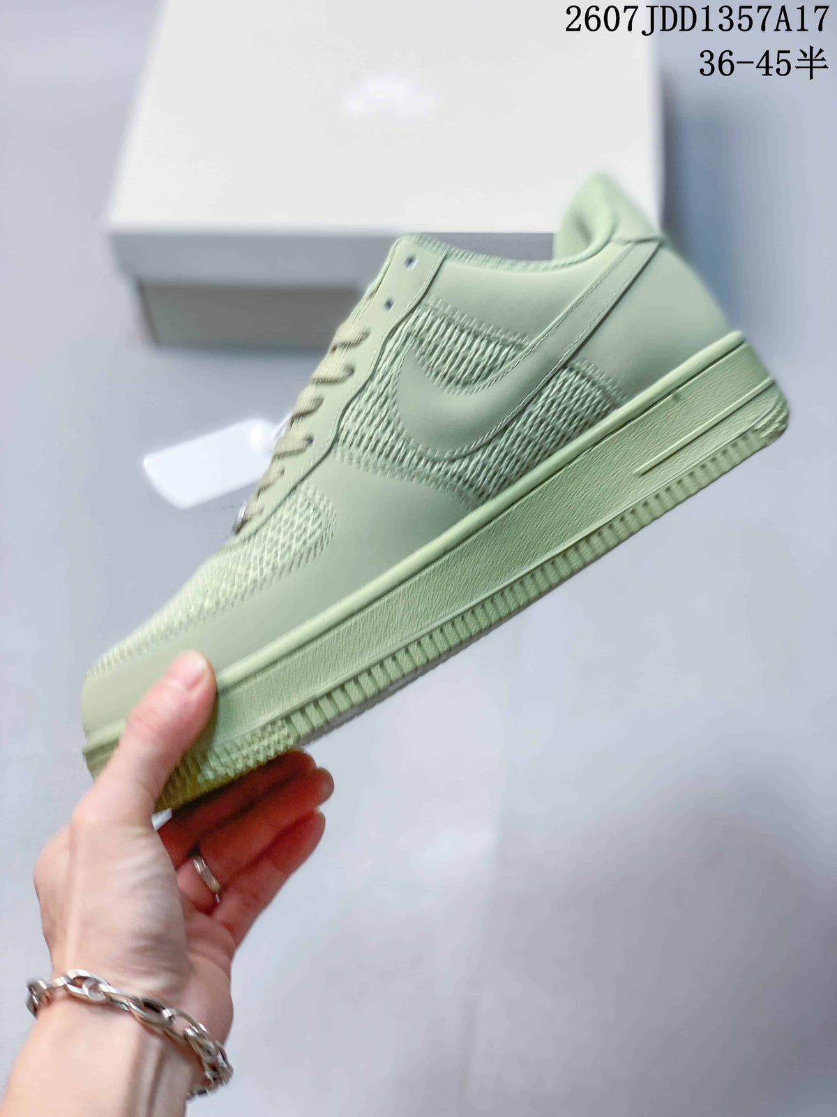 Side profile of the pale green low-top sneaker with layered panels, woven sections and a tonal sole.