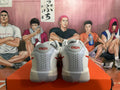 Rear view of white and red Nike basketball shoes showing heel panels and perforations.