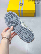 Grey outsole of a Nike SB Dunk Low sneaker with a yellow box in the background
