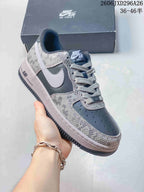 Close-up of a charcoal Nike Air Force 1 sneaker with patterned panels and a light Swoosh.