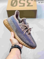 Multicolor gray and beige Adidas Yeezy-style sneaker with a tan ridged sole.