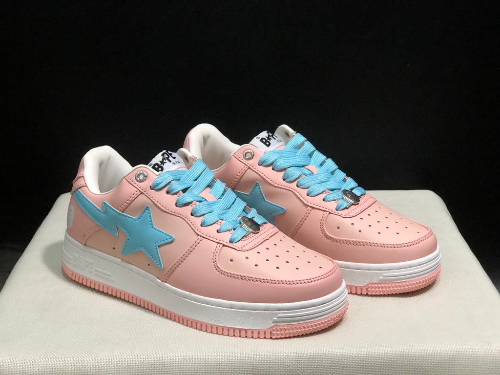 Three-quarter front view of the pink and light-blue low-top sneakers with perforated toe boxes and white midsoles.
