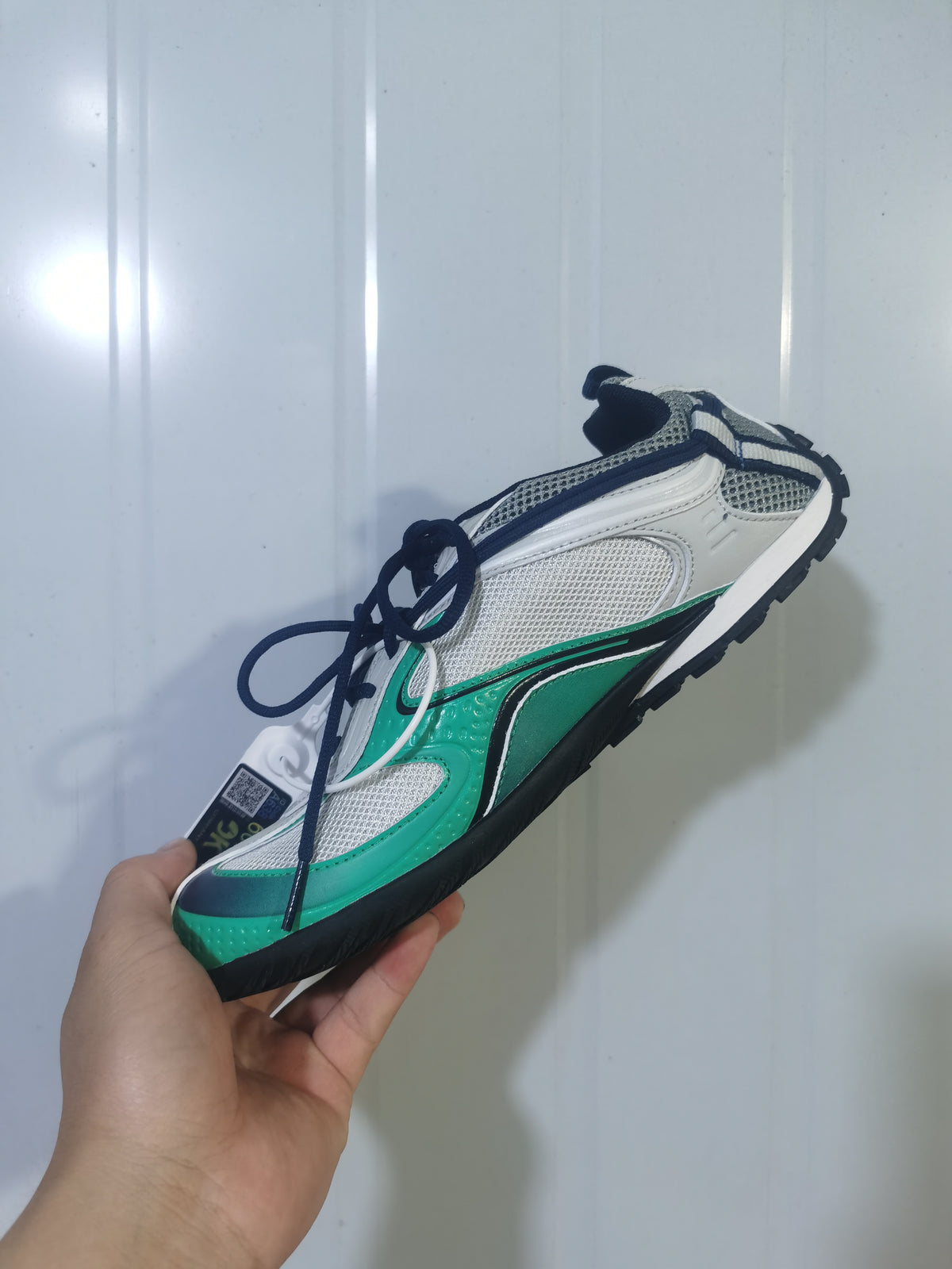 Top and side view of the Balenciaga Radar sneaker showing its contrasting panels, laces and rugged black outsole.