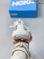 Rear view of the white sandal showing the heel strap and layered outsole.
