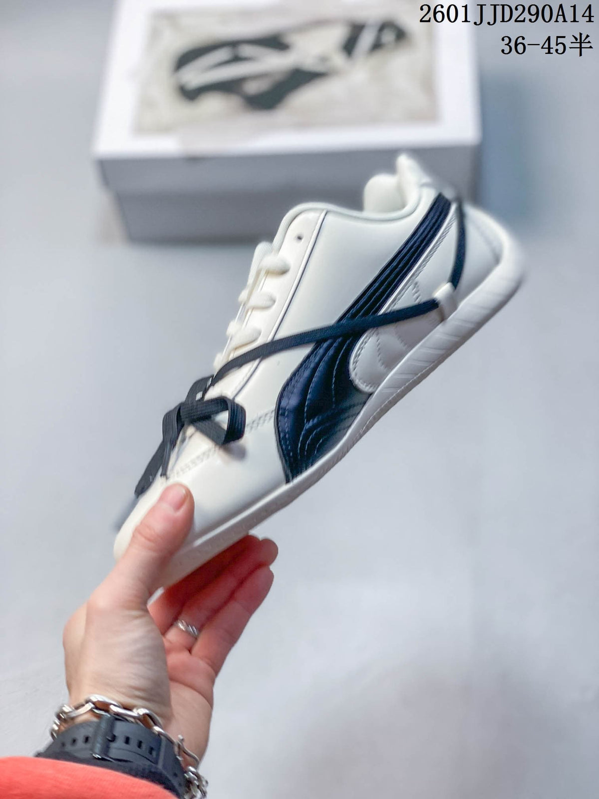 Side view of the PUMA Speedcat TTF sneaker showing navy layered branding, off-white panels, and lace-up fastening.