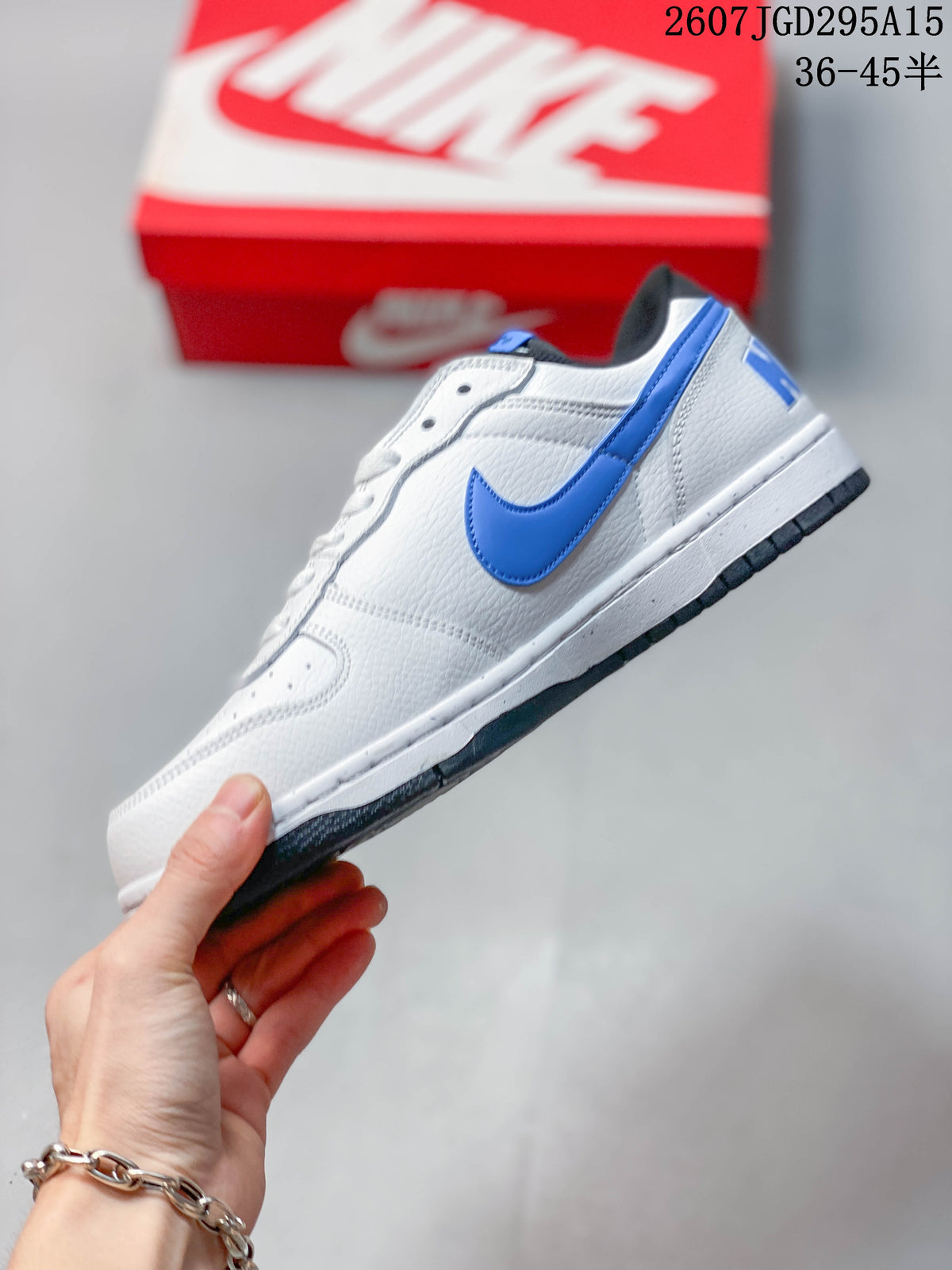 Side profile showing the blue Swoosh, white upper, white midsole and black outsole.
