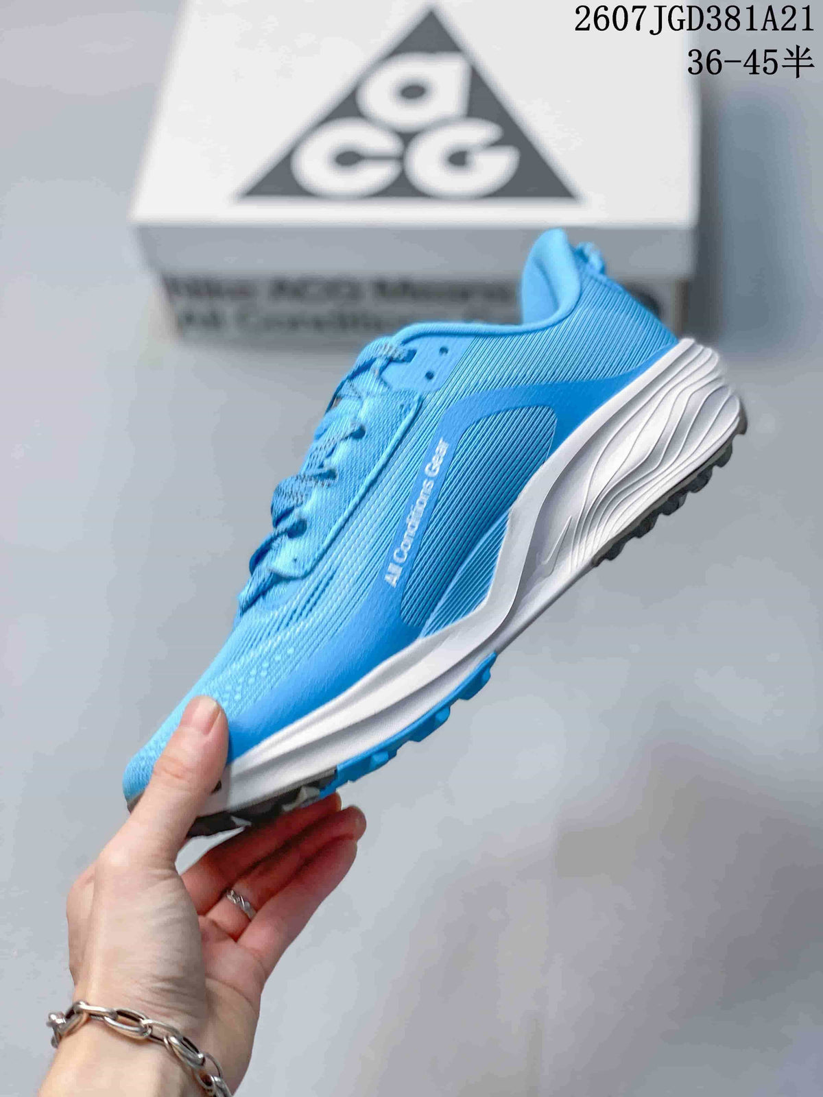 Side view of the blue Nike ACG Pegasus Trail sneaker showing the textured upper, white midsole, and dark outsole.