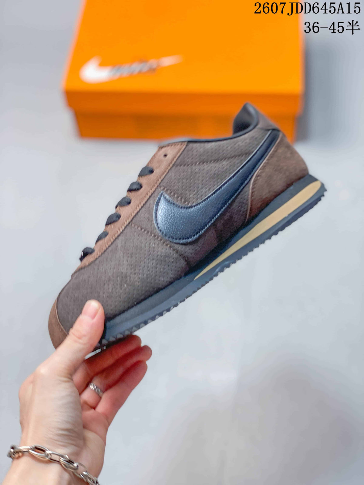 Side view of the sneaker showing the contrasting dark Swoosh, brown upper, lace-up construction, and layered sole.