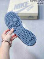Blue rubber outsole of the sneaker showing circular traction at the forefoot and segmented tread at the heel.