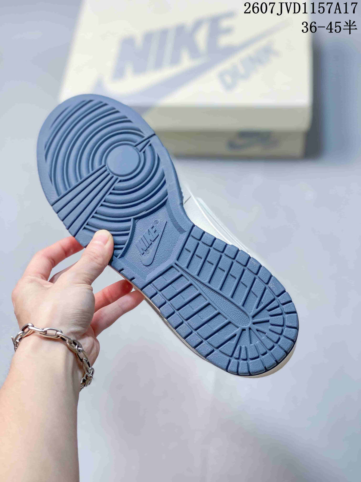 Blue rubber outsole of the sneaker showing circular traction at the forefoot and segmented tread at the heel.