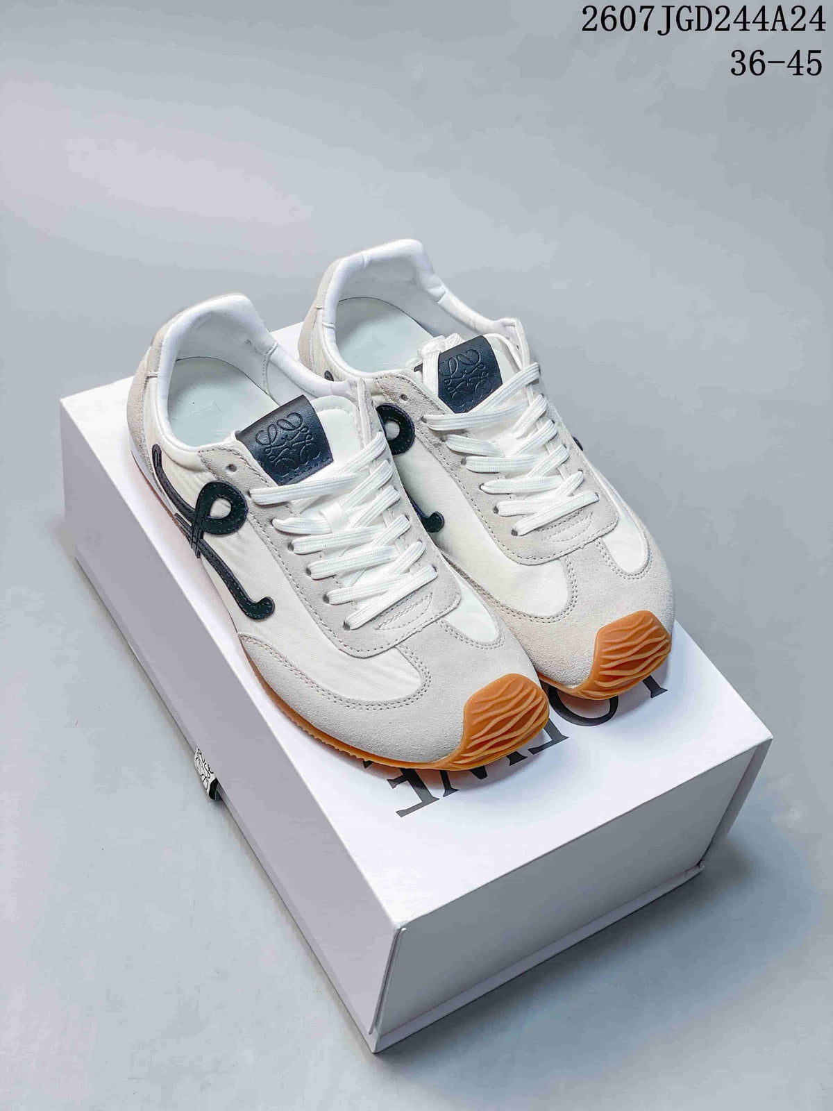 Pair of white LOEWE Ballet Runner 2.0 sneakers with black side detailing and gum outsoles displayed on a shoe box.