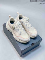 Pair of off-white DESCENTE sneakers with dial-adjustable wire lacing on a branded box
