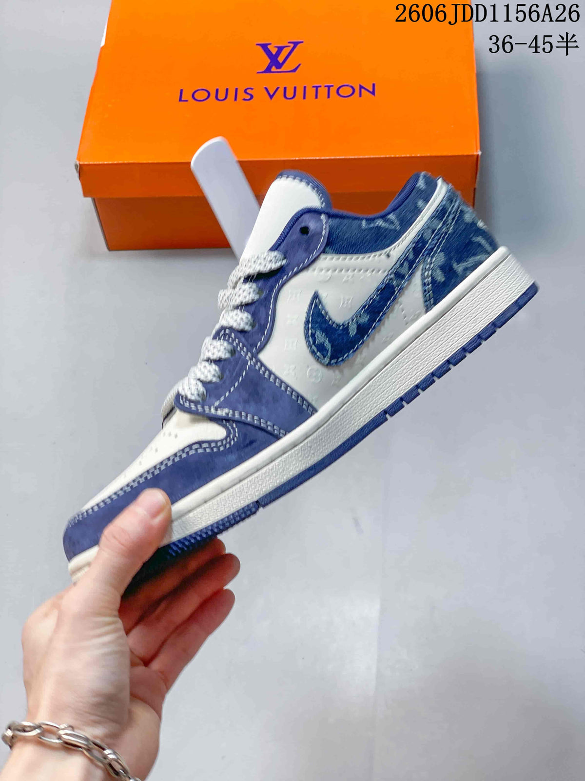 Side profile of the blue and white low-top sneaker showing layered upper panels, a contrasting swoosh-shaped mark, white midsole, and blue outsole.