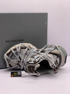 Top-side view of one sneaker showing the layered lace construction, padded collar, and attached product tag.