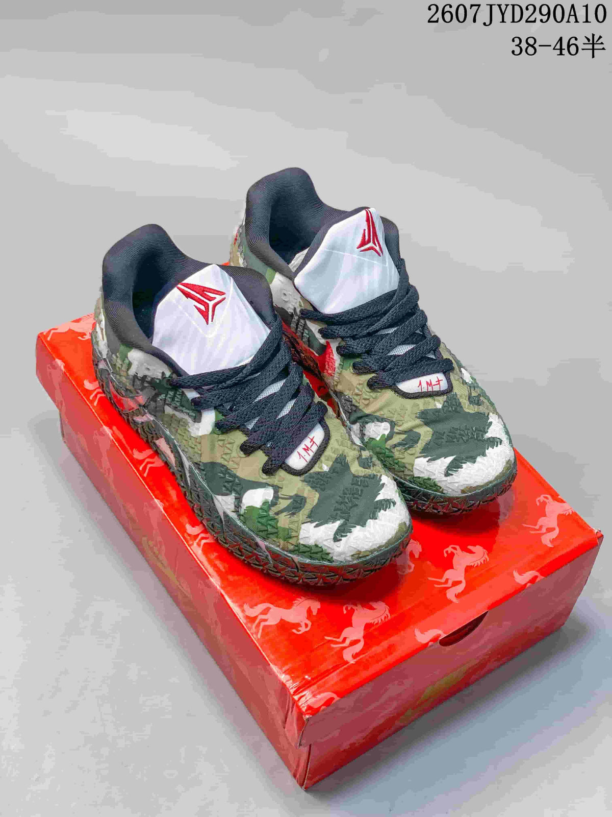 Pair of Nike Ja 3 basketball shoes in green camouflage-style detailing displayed on a red horse-patterned box.