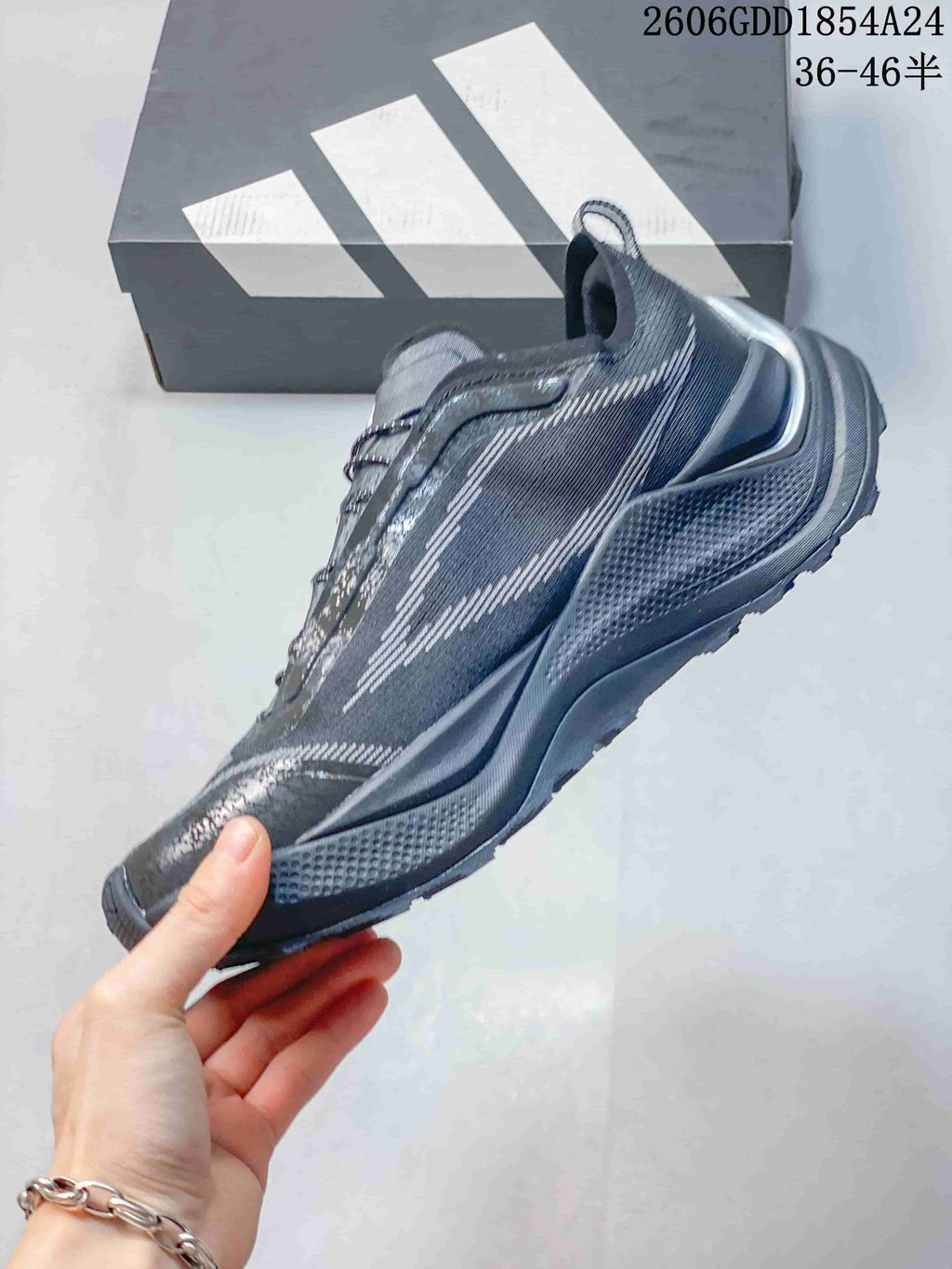 Side view of a dark gray low-top trail running shoe