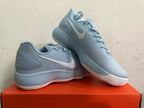 Pair of light blue Nike basketball shoes shown from the side.