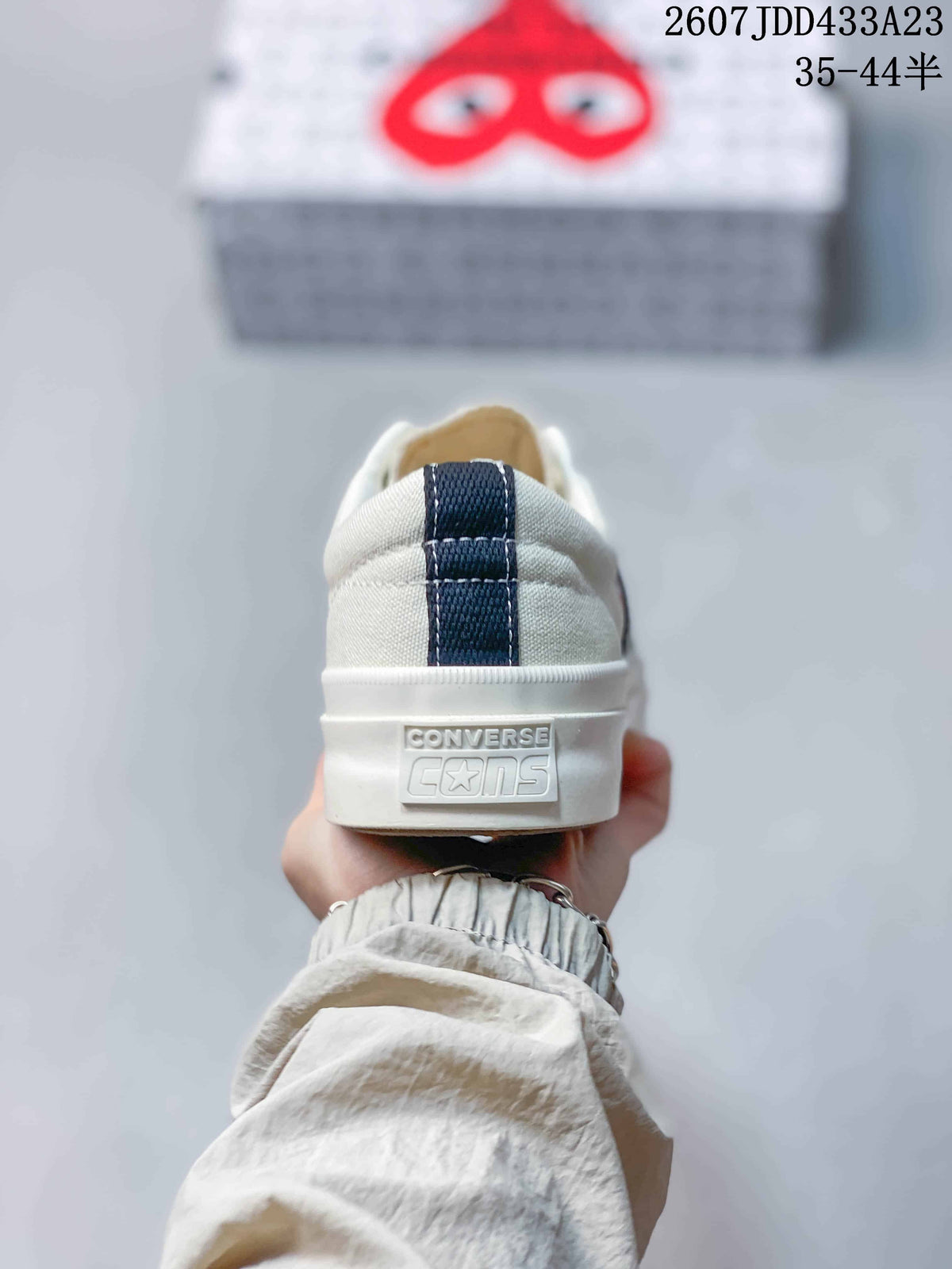Rear view showing the white heel panel, dark heel pull tab and Converse branding on the sole.