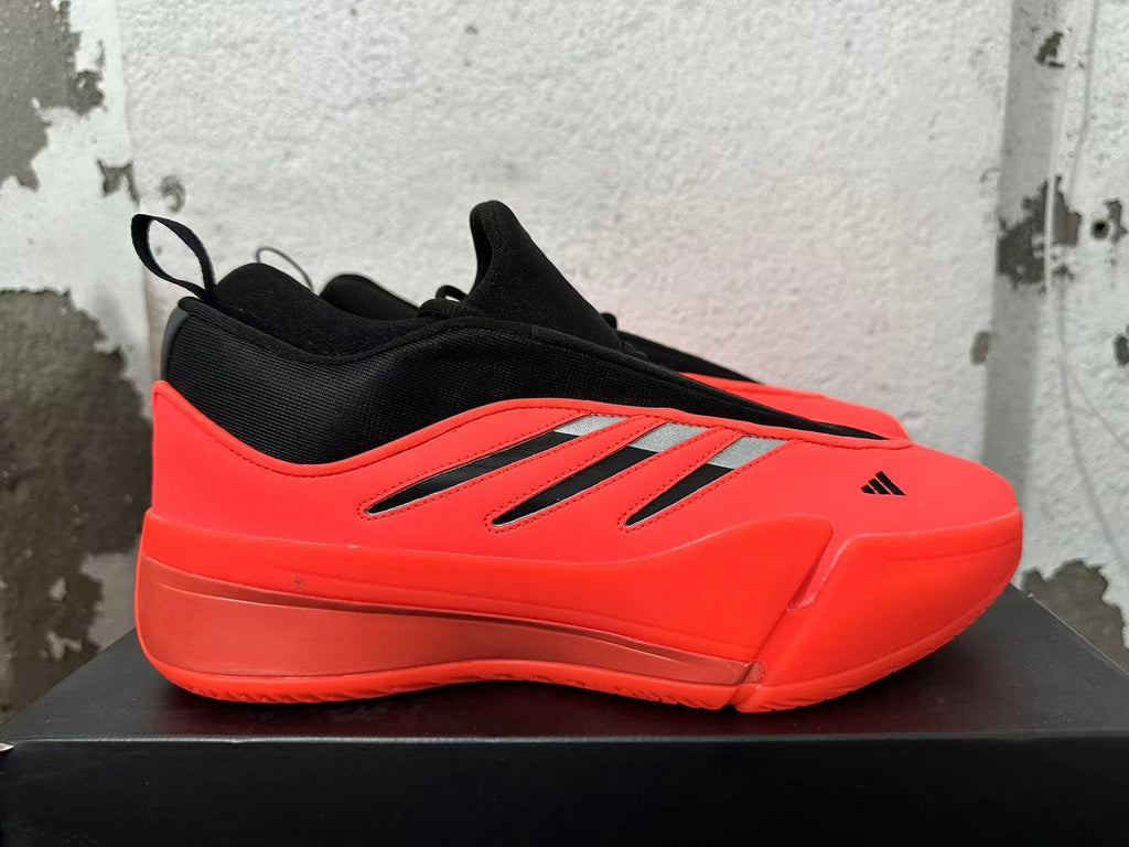 Side view showing the red upper, black details and silver accents