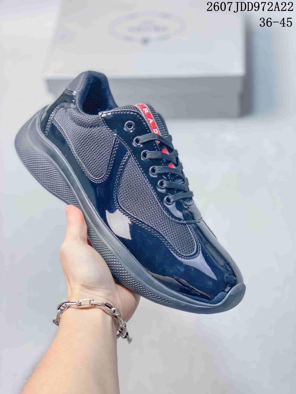 All-black Prada America's Cup low-top sneaker with a dark textured sole.