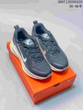 Nike Vomero 18 sneakers shown from the front on an orange shoebox, with dark uppers, white Swoosh logos, and a light-colored midsole; image text shows TD295A25 and size range 36–46.5.