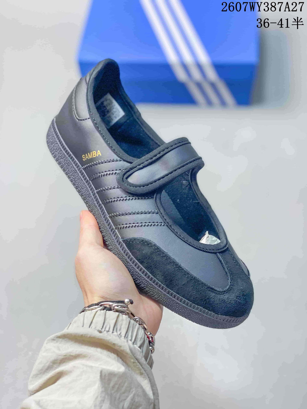 Close-up of a black Samba Jane sneaker with tonal stripes, a hook-and-loop strap and textured toe panel.