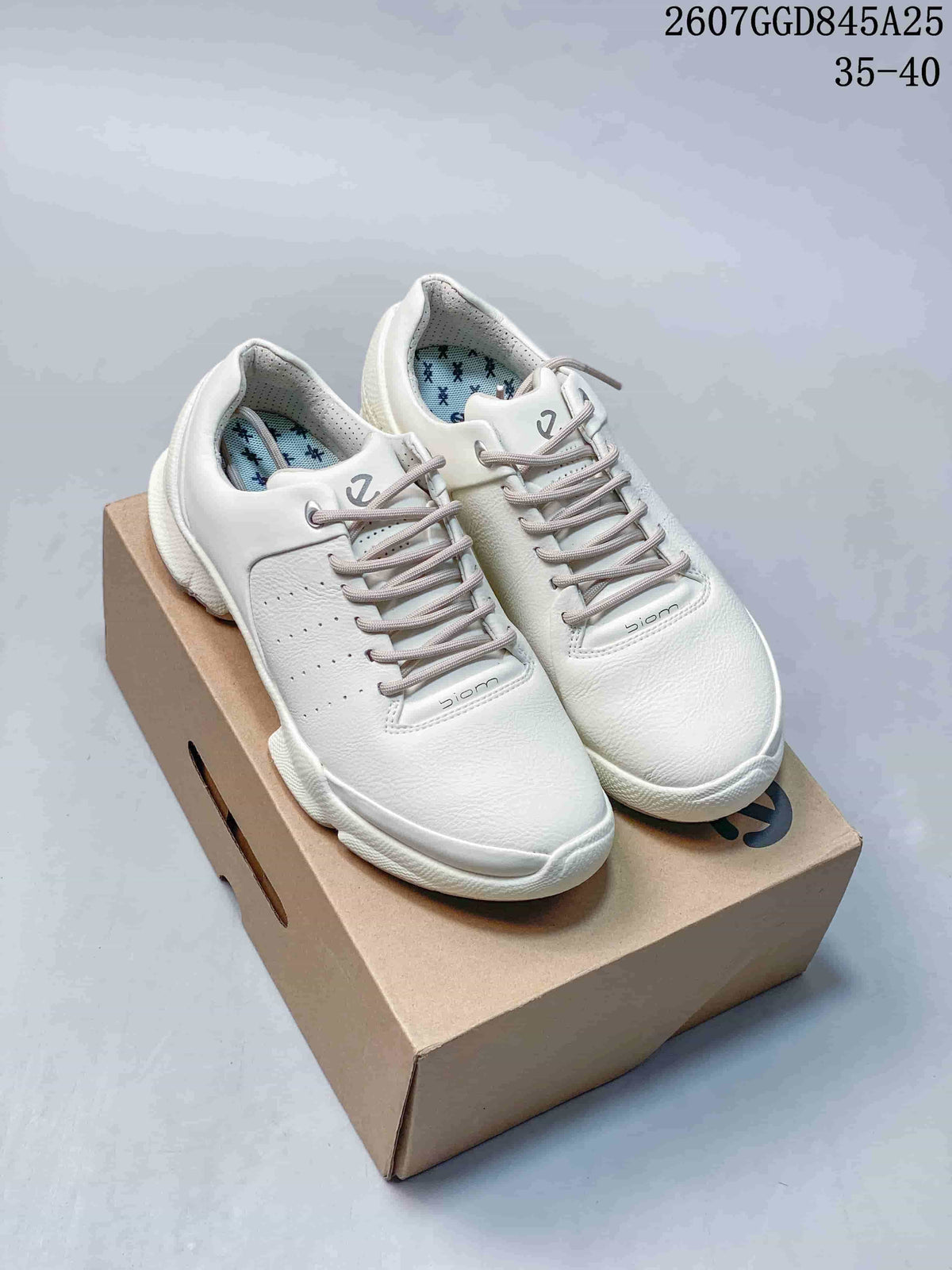 Front three-quarter view of white ECCO Biom C sneakers on a shoebox, showing the rounded toe, lace-up closure and visible Biom branding.