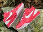 Pair of pink Nike Kobe 4 shoes shown at angled side views.