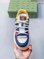 Top view showing white rope-style laces, navy and red overlays, yellow collar lining, and the Gucci and Senma tongue labels.