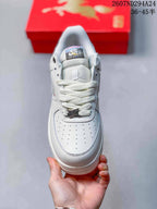 Top view of the white sneaker showing the perforated toe box, white laces, padded tongue and lace accessory.