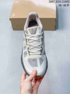 Front view of the sneaker highlighting its mesh-like panels and laces