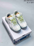 Pair of white and lime FILA Pebble low-top sneakers displayed on a shoebox