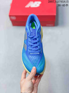 Top view of the blue lace-up running shoe showing the perforated toe area, blue tongue, and contrasting green insole detail.