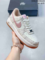 Close-up of a cream Nike Air Force 1 sneaker with pink Swoosh and gum-tone outsole.