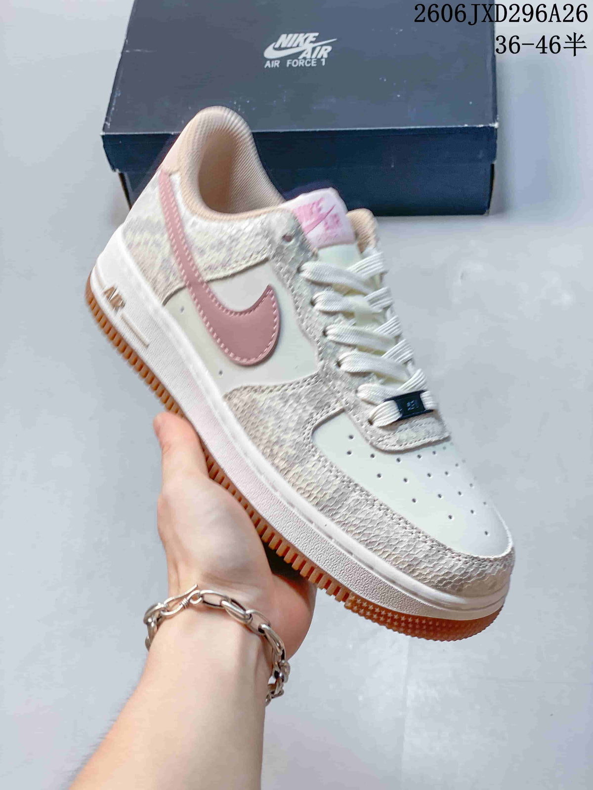 Close-up of a cream Nike Air Force 1 sneaker with pink Swoosh and gum-tone outsole.