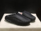 Three-quarter view of the black pair highlighting the textured upper and thick sculpted outsole.
