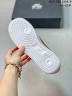 View of the white outsole showing concentric circular traction patterns and a central embossed logo.