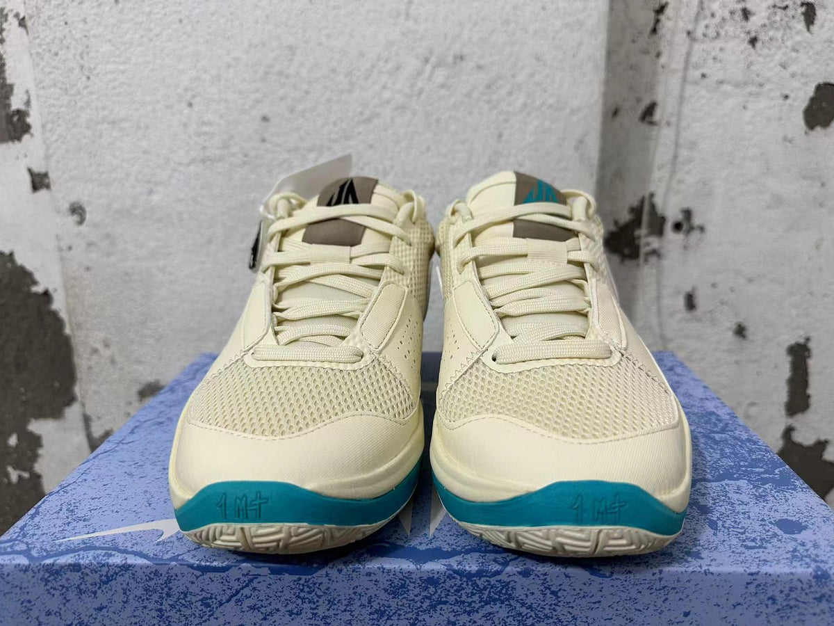 Front view showing the mesh toe areas, laces, and teal accents on Nike Ja 1 shoes