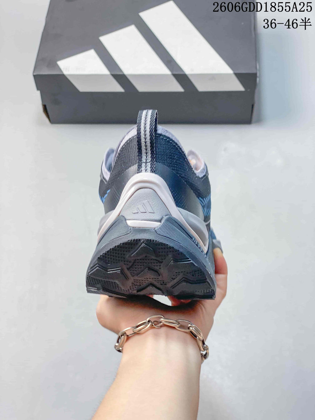 Rear view of the gray and blue trail running shoe showing the heel and outsole