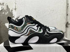Side profile of Jordan sneakers showing camouflage panels, Jumpman logo, and sculpted sole
