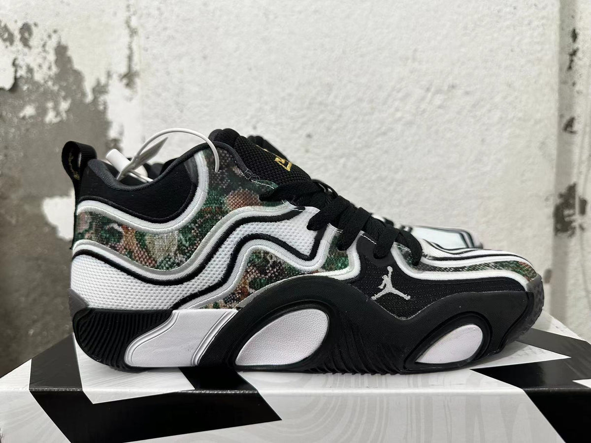 Side profile of Jordan sneakers showing camouflage panels, Jumpman logo, and sculpted sole