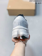 Rear view of the white shoe showing the On branding, dark heel detail, and sculpted outsole; the image displays style code 2607JGD492A22 and size range 36–46.