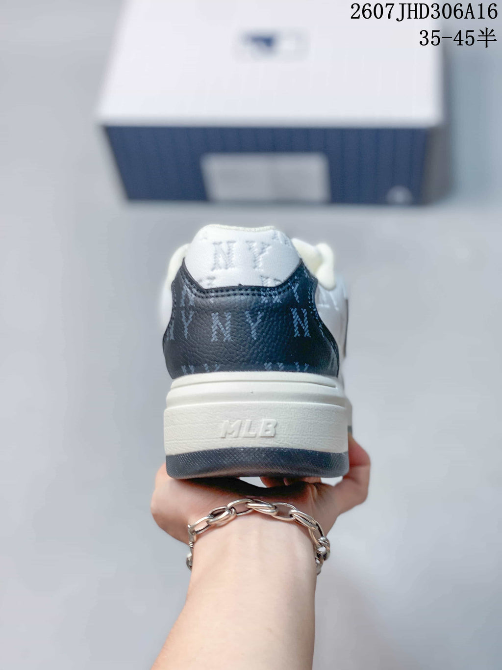 Rear view of the sneaker showing the navy heel panel, white padded collar, and MLB branding on the sole.