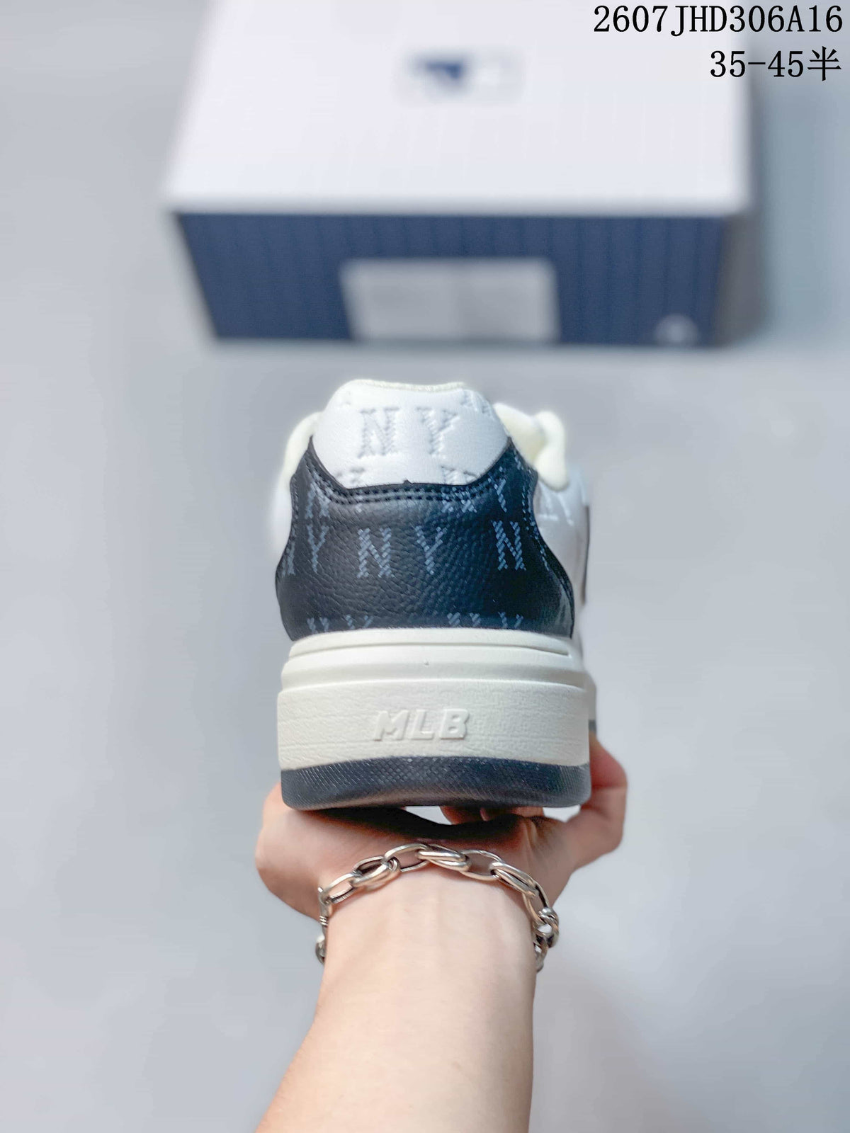 Rear view of the sneaker showing the navy heel panel, white padded collar, and MLB branding on the sole.